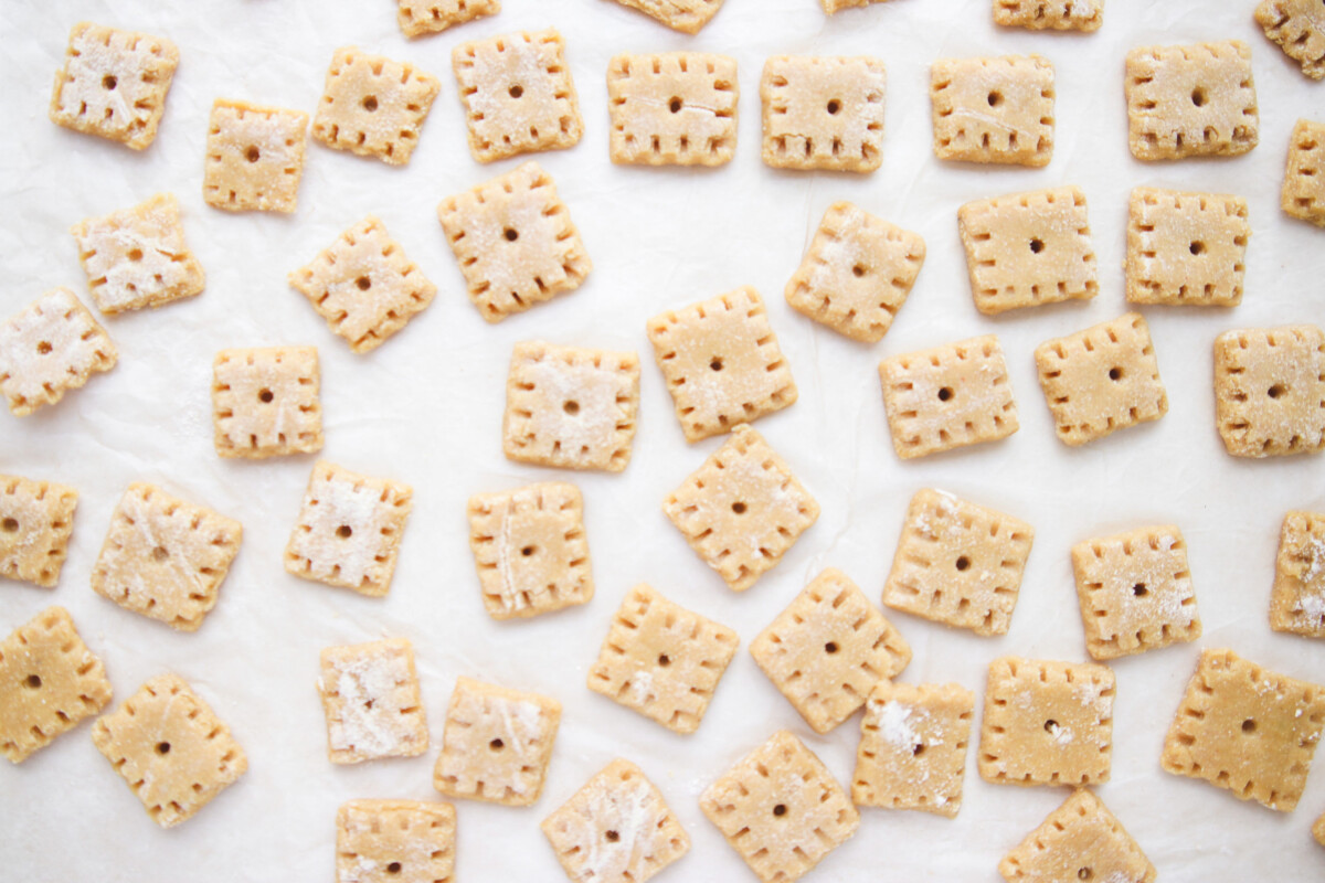 an overhead shot of cheez-it crackers on a sheet of parchment paper