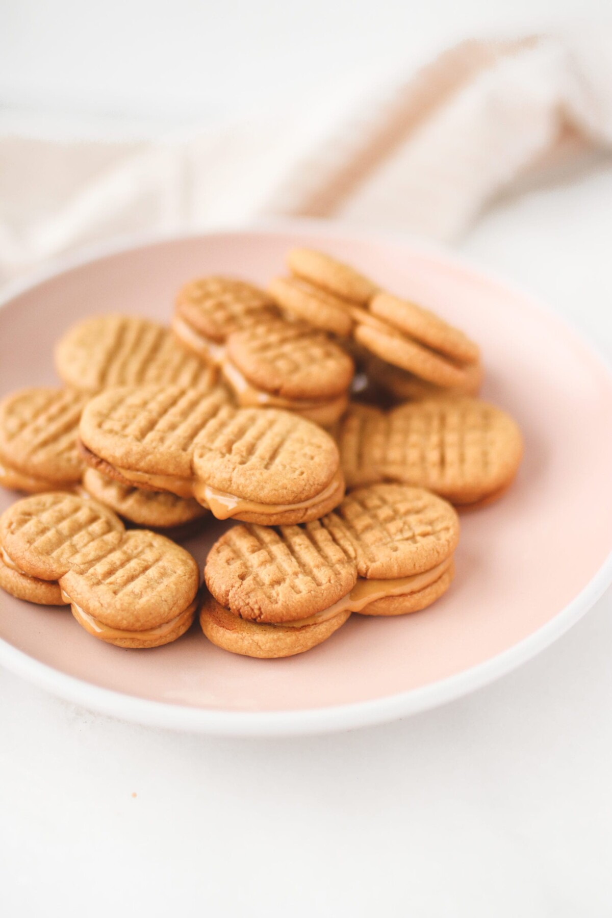 a stack of cookies on a pink plate