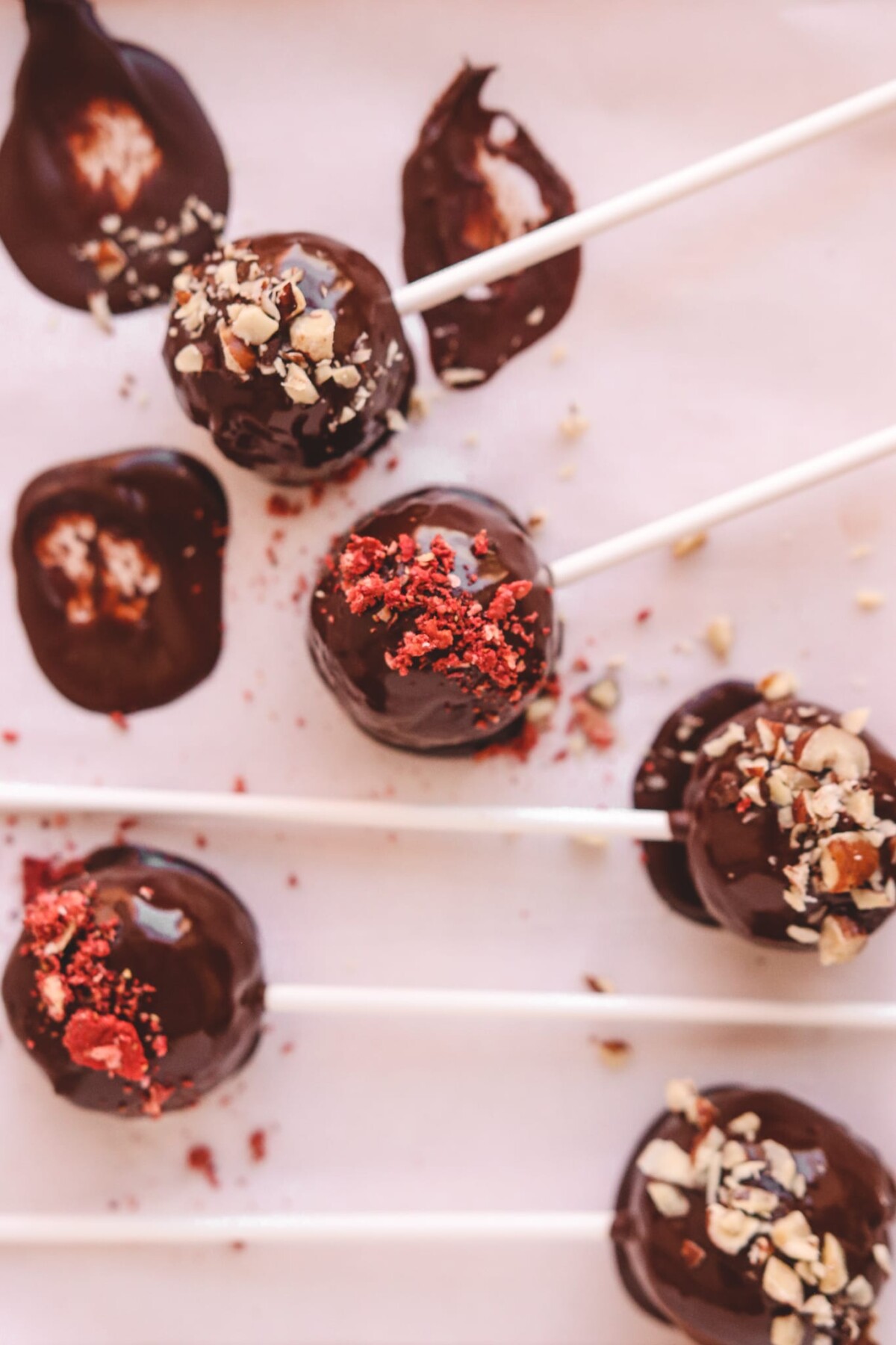 balls of cake on a stick and topped with nuts