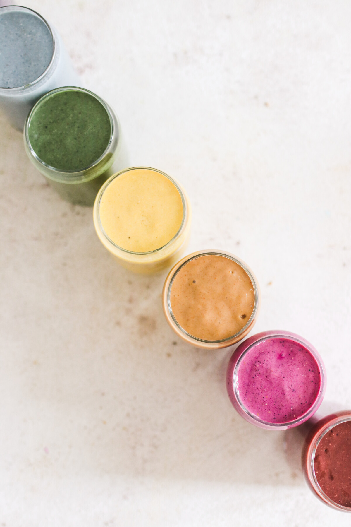 an array of smoothies lined up next to each other