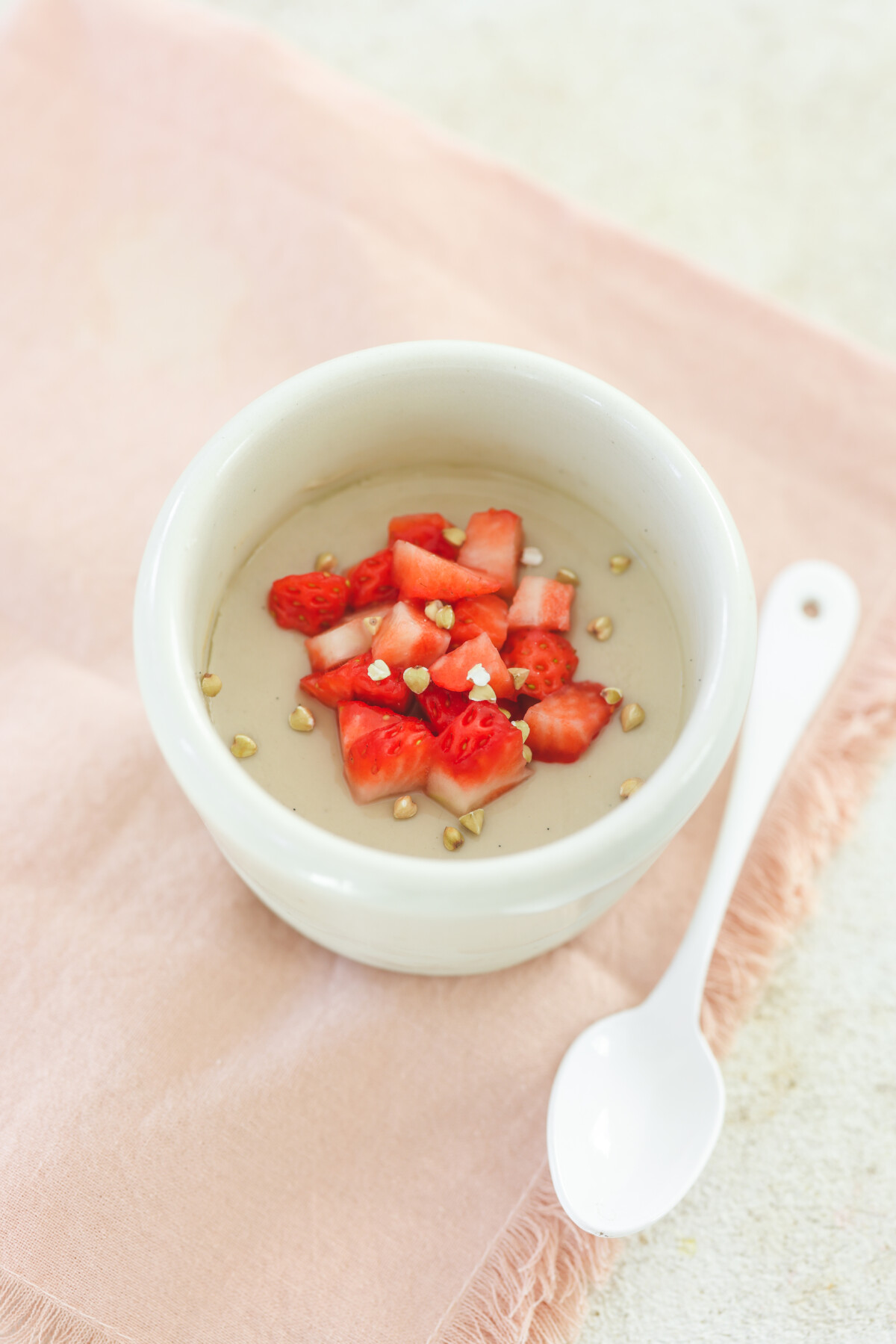 vegan panna cotta topped with fresh strawberries