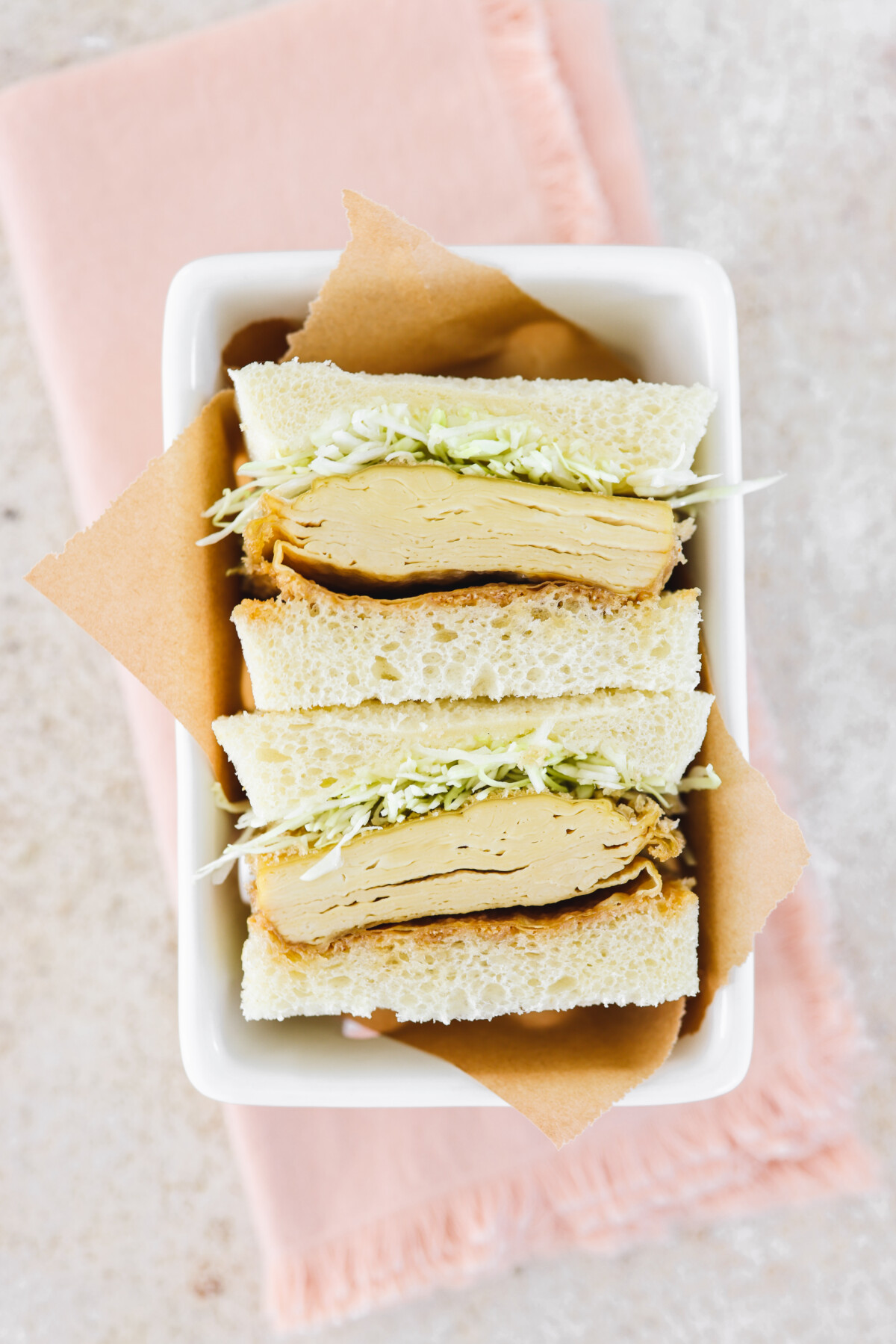 and overhead shot of a Japanese sandwich in a white serving tray
