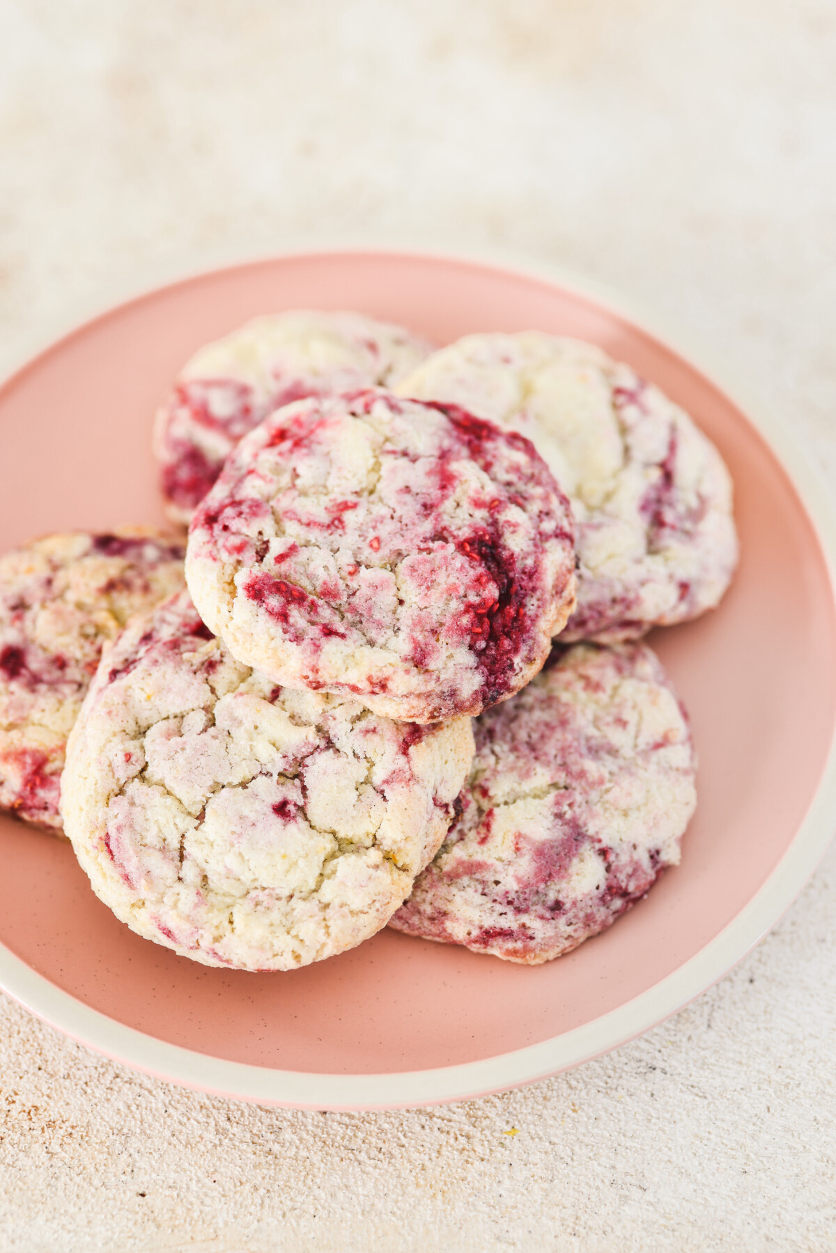 a plate of raspberry lemon cookies stacked on top of each other
