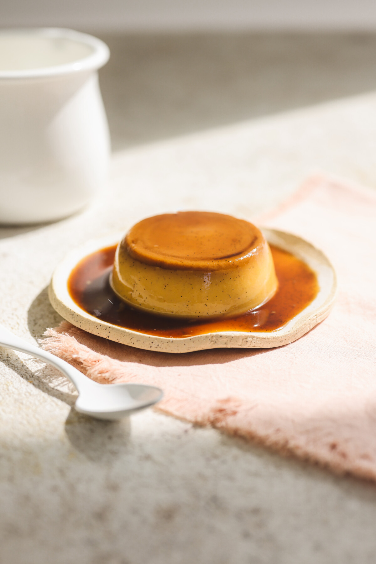 a plate of vegan flan topped with homemade coconut syrup
