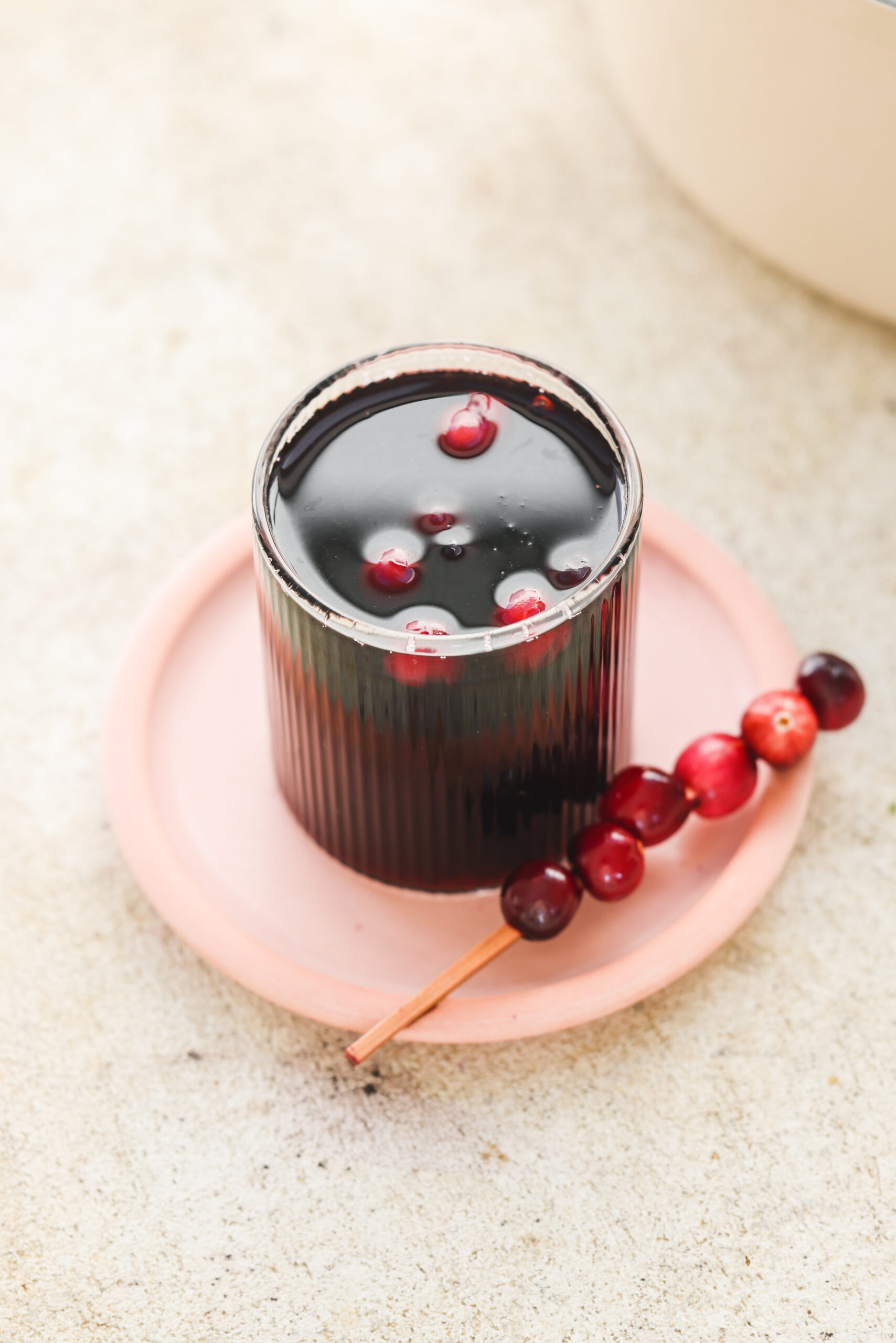 non alcoholic mulled wine in a glass with fresh cranberries