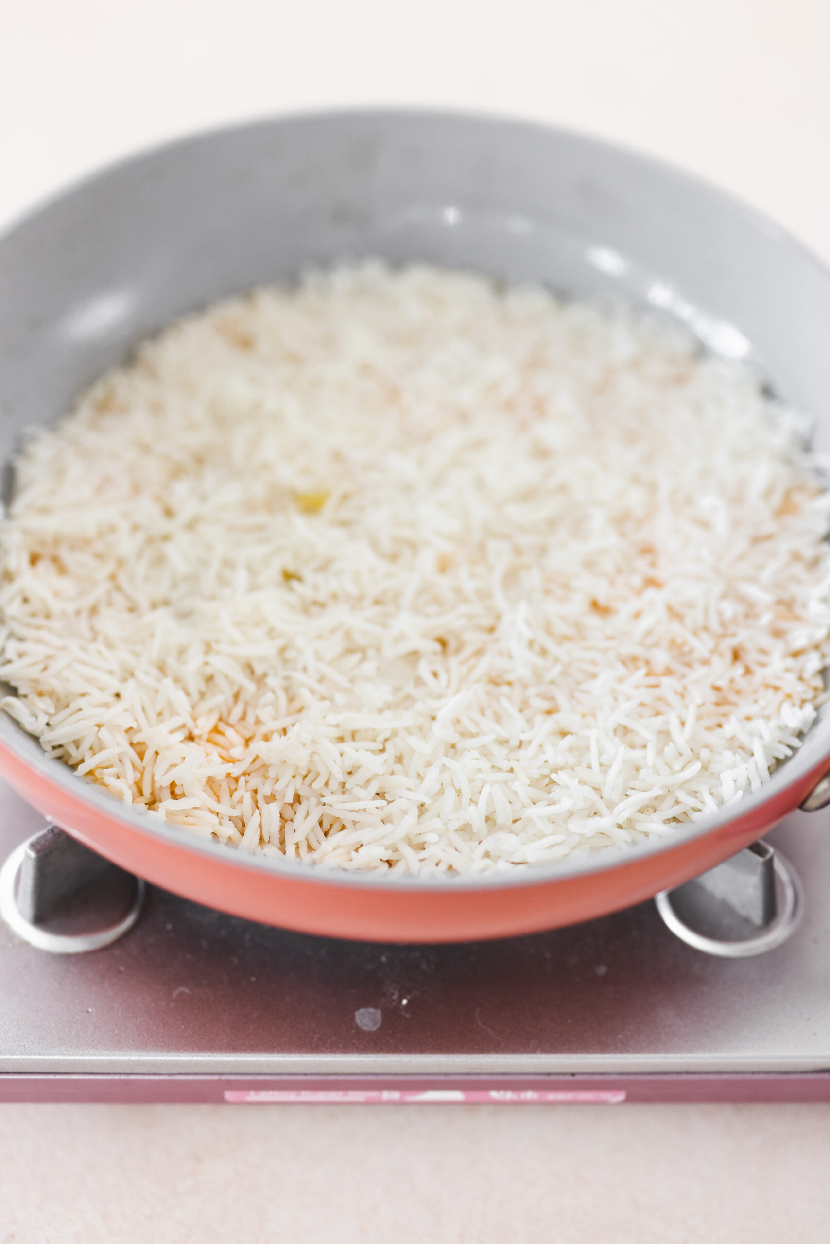 a skillet cooking crispy persian rice 